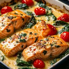 salmon with spinach, tomatoes and cheese in a casserole dish