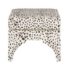 an animal print foot stool with black and white spots