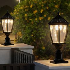 two lamps are sitting on the side of a building