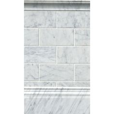 a white marble tile wall with an ornate border