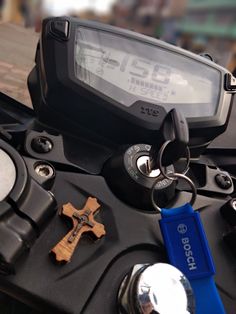 a close up of a motorcycle keychain with a digital clock on it's side