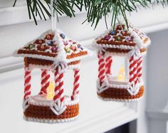 two christmas ornaments hanging from a tree