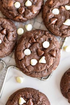 chocolate cookies with marshmallows are on a cooling rack, ready to be eaten