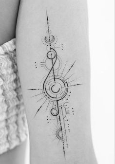 a black and white photo of a woman's arm with music notes on it