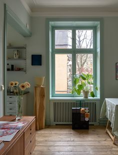 a room with a table and two windows