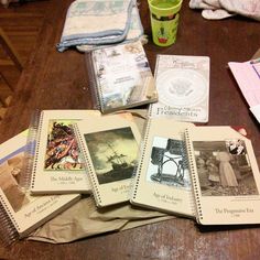 a table topped with lots of books and papers