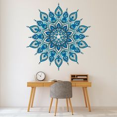 a desk with a chair and a wall sticker in the shape of a flower