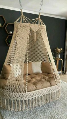 a hammock bed hanging from the ceiling in a living room