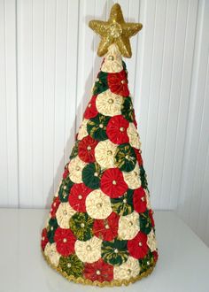 a crocheted christmas tree with gold star on top