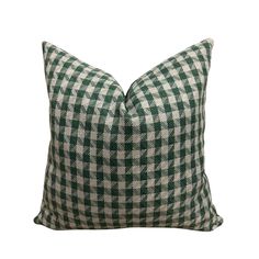 a green and white checkered pillow on a white background