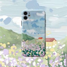 a phone case with an image of a house in the middle of a flower field