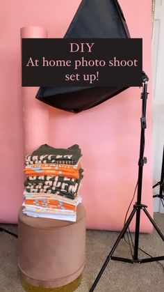 a photo shoot set up in front of a pink wall with a black sign that says diy at home photo shoot set up