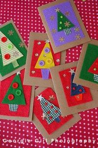 several christmas cards are laid out on a red and white checkered tablecloth with buttons