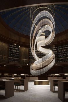 a circular chandelier hanging from the ceiling in a library