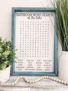 a bathroom word search is displayed on a shelf next to a potted plant and bead necklace