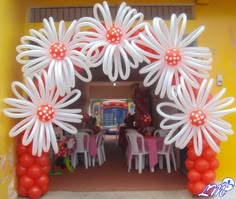 an arch decorated with balloons and flowers