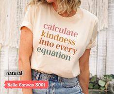 a woman wearing a t - shirt that says, calculate kindness into every equal