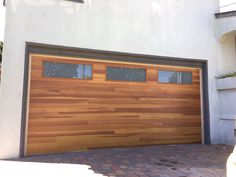 a wooden garage door is shown in front of a house