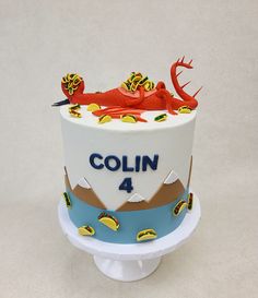 a cake decorated to look like a mountain with a lobster on top and the name colin 4