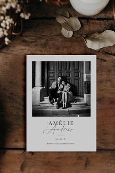 an old fashioned photo with the words amelie on it is sitting next to a candle and some flowers