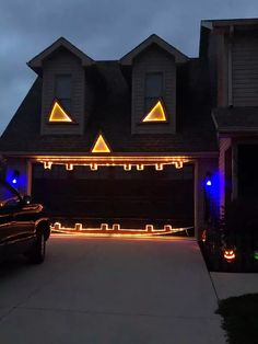 a car parked in front of a house decorated with halloween lights