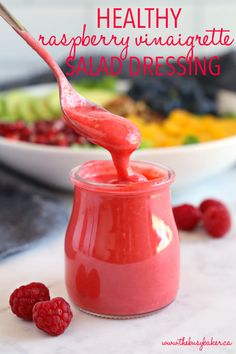 raspberry vinaigrete salad dressing in a small jar with a spoon