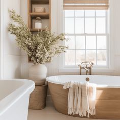 a bathroom with a large tub and window