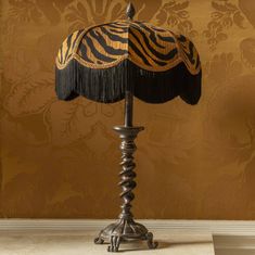 a zebra print lamp on a table in front of a wall