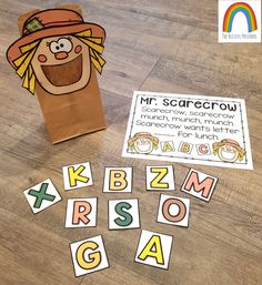 a paper bag with the words mr scarecrow on it next to some cut out letters