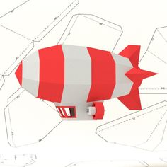 a paper model of a red and white rocket with cut out parts on the side