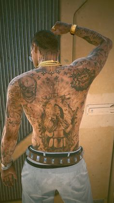 a man with many tattoos on his back