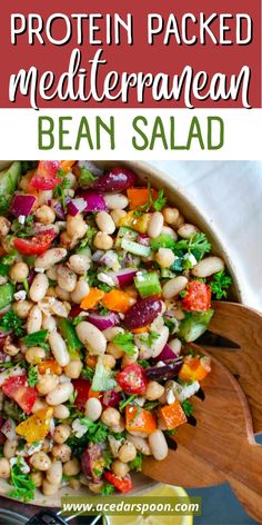 a salad with beans, carrots and lettuce in it