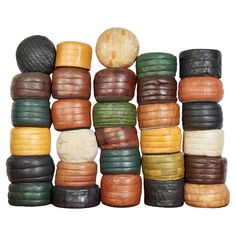 a pile of different colored tires stacked on top of each other in front of a white background