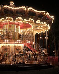 a merry go round at night with lights on