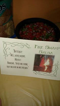 a sign that says fire swamp salsa next to a bowl of tortilla chips