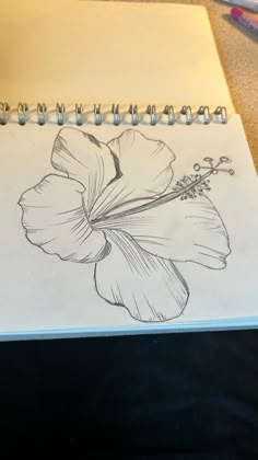 a drawing of a flower on a notebook