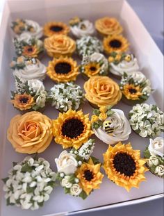 a box filled with lots of fake sunflowers and flowers on top of each other