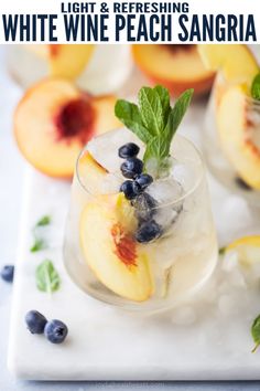 white wine peach sangria with blueberries and mint garnish