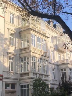 a large white building with balconies and windows