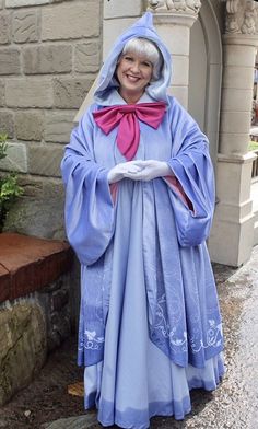 an older woman dressed in a blue costume