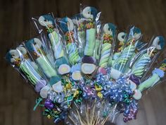 a vase filled with lots of candy and candies on top of a wooden table