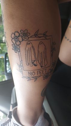 a tattoo on the leg of a woman with two ghost hands and no feet in front of her