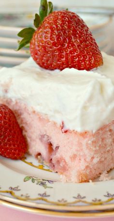 a slice of strawberry cream pie on a plate with strawberries in the foreground