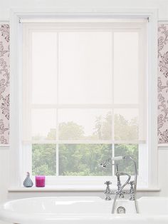 a white bath tub sitting next to a window