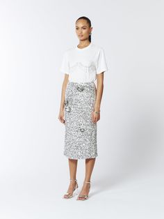 Turn up the sparkle with this stunning midi skirt. Adorned with shimmering silver sequins and embellished further with clusters of 3D paillette flowers, this skirt adds beautiful dimension and captivating elegance.  Hand-embroidered paillettes  Midi-Length  Fits true to size, take your normal size. Model is 5'9" / 174cm and wears a size UK6 (US2 / EU34) Main: 100% Polyester Lining: 95% Polyester 5% Elastane  Dry Clean Only Turn inside out before cleaning Do not tumble dry Iron on low heat, maxim Silver Sequin Skirt, Fringe Tshirt, Stocking Fillers For Her, Pearl Jewellery Earrings, Skirt Outfit, Minimalist Prints, Silver Sequin, Turn Up, Navy Pink