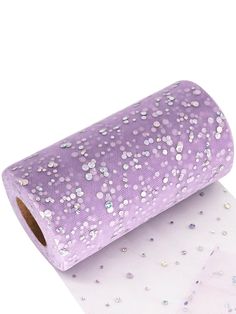 a roll of purple sequinized paper on top of a white sheet of paper