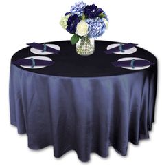 a round table topped with purple and white flowers