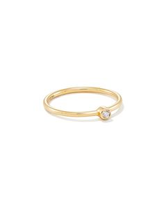 Simple enough to stack, sophisticated enough to shine on its own. The Audrey 14k Yellow Gold Band Ring in White Diamond is a modern take on a classic, crafted with a solitary bezel-set White Diamond. 

 We have taken steps to ensure that, when applicable, our diamonds are conflict free by requiring our suppliers to comply with the Kimberley Process. Gold Ear Jacket, Jacket Earrings, Ear Jacket, Gold Band Ring, Diamond Sizes, Gold Band, Strand Necklace, Kendra Scott, Yellow Gold Rings