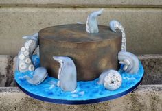 there is a cake that has dolphins on it