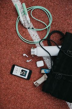 an electronic device and other items are laying on the ground